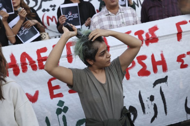 ATHENS, GREECE - SEPTEMBER 24: People gather at the Sintagma Square in Athens, Greece on September 24, 2022 to protest against the killing of Iranian government after the death of a 22-year-old Mahsa Amini under custody in Tehran, Iran. (Photo by Ayhan Mehmet/Anadolu Agency via Getty Images)