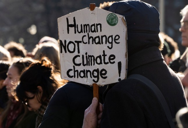 A protestor held a sign as Extinction Rebellion activists and sympathisers blocked a busy road in The Hague, Netherlands, Saturday, Jan. 28, 2023. Earlier this week seven Extinction Rebellion activists were detained by authorities for sedition linked to the protest. (AP Photo/Peter Dejong)