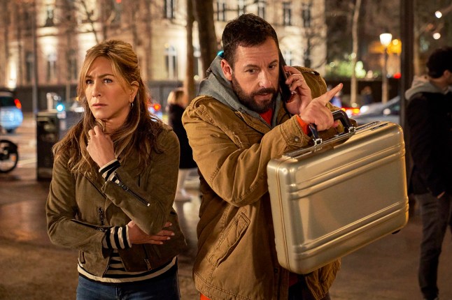 This image released by Netflix shows Jennifer Aniston, left, and Adam Sandler in a scene from the film "Murder Mystery 2." (Scott Yamano/Netflix via AP)