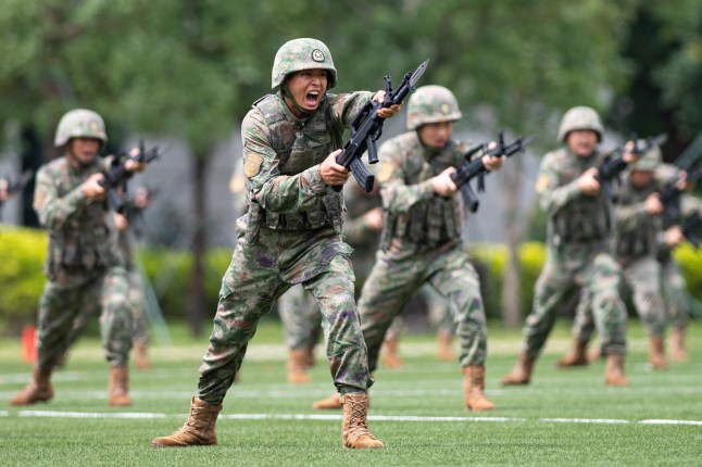 epa10602202 Soldiers of the Chinese People's Liberation Army (PLA) Garrison stationed in the Macao Special Administrative Region stage military exercises during an open day event at the barracks on Taipa Island in Macao, south China, 30 April 2023 (issued 01 May 2023). This was the 17th time that the barracks had been opened to the public since 2005, helping with communication between the garrison and local residents. EPA/XINHUA / CHEONG KAM KA CHINA OUT / MANDATORY CREDIT EDITORIAL USE ONLY