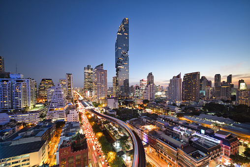 Aerial view of Bangkok modern office buildings, condominium, living place in Bangkok city downtown with sunset scenery, Thailand