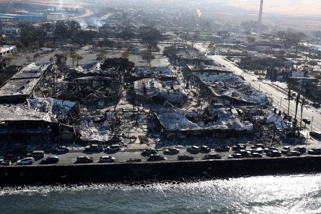 LAHAINA, HAWAII - AUGUST 11: In an aerial view, cars destroyed by wildfire line Front Street on August 11, 2023 in Lahaina, Hawaii. Dozens of people were killed and thousands were displaced after a wind-driven wildfire devastated the town of Lahaina on Tuesday. Crews are continuing to search for missing people. (Photo by Justin Sullivan/Getty Images) *BESTPIX*