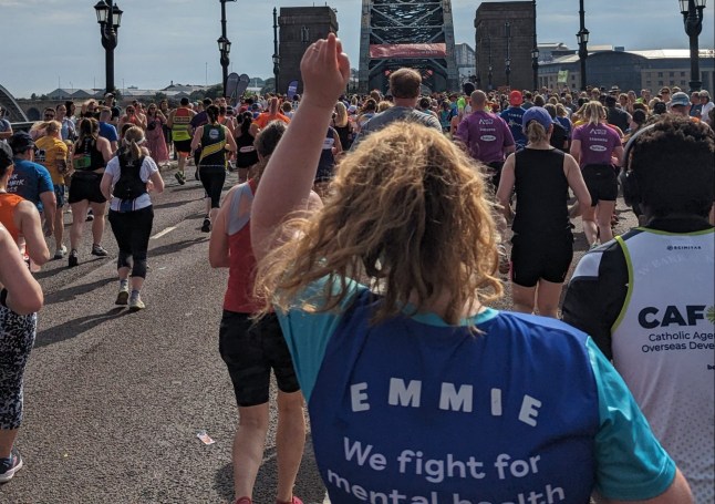 Emmie Harrison-West while running the Great North Run. Picture is taken from behind - Emmie's hand is in the air and there are runners all around her. Picture: Emmie Harrison-West