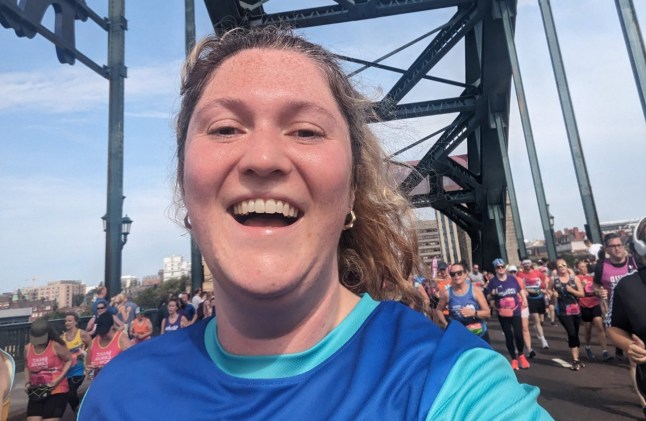 Emmie Harrison-West taking a selfie while running the Great North Run, on a bridge with oher runners behind her. Picture: Emmie-Harrison West