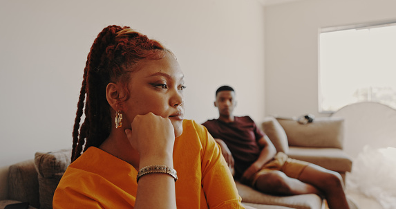 Shot of a young woman ignoring her bf at home