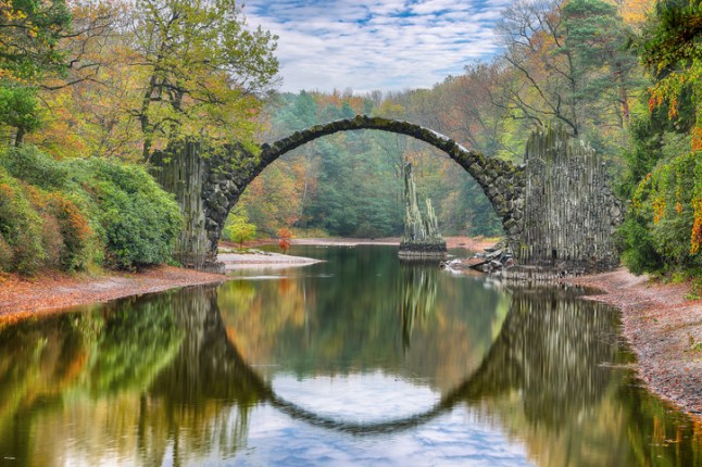 Fabulous autumn landscape in Azalea and Rhododendron Park Kromlau. Rakotz Bridge (Rakotzbrucke, Devil's Bridge)