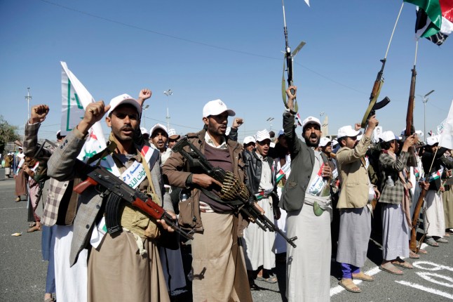 SANA'A, YEMEN - DECEMBER 02: Yemenis recently militarily trained by the Houthi movement hold their guns and chant slogans as they take part in an armed popular parade held in Al-Sabeen Square to get ready to go and fight Israel in the Gaza Strip, on December 02, 2023 in Sana'a, Yemen. Thousands of Yemenis recently recruited by the Houthi military forces participated in an armed popular parade held to express readiness for heading to the Gaza Strip and fighting with Palestinians against Israel in response to Israel's war resumption in Gaza. (Photo by Mohammed Hamoud Hamoud/Getty Images)