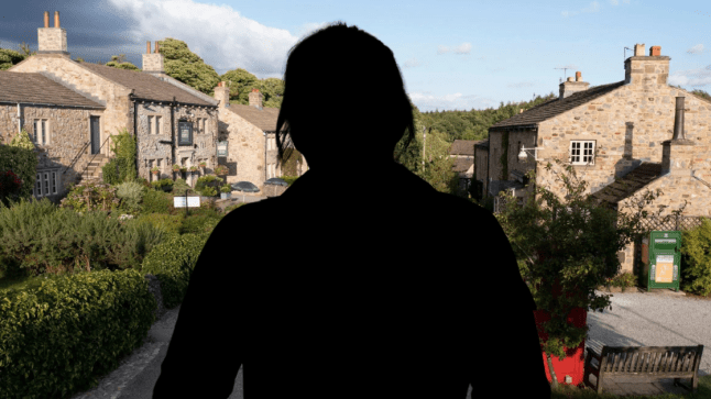 Silhouette of a woman in front of the Emmerdale village