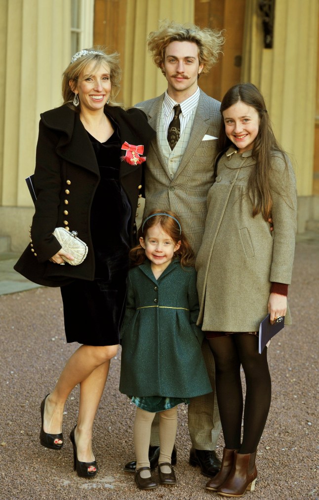 LONDON, UNITED KINGDOM - DECEMBER 14: Sam Taylor-Wood wears her OBE with partner Aaron Johnson and her children Angelica (R) and Jessie after it was presented to her by Prince Charles, Prince of Wales during an Investiture Ceremony at Buckingham Palace on December 14, 2011 in London. (Photo by John Stillwell - WPA Pool/Getty Images)