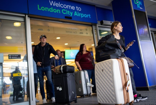 Mandatory Credit: Photo by TOLGA AKMEN/EPA-EFE/Shutterstock (12942431b) People leave London City Airport in London, Britain, 16 May 2022. Travelers are no longer required to wear face masks on airplanes and at airports as of May 16, according to the European Union Aviation Safety Agency (EASA) and European Center for Disease Prevention and Control (ECDC) rules. Europe removes face mask requirement on flights, London, United Kingdom - 16 May 2022