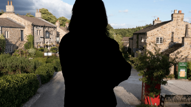 Silhouette of a woman in front of the Emmerdale village