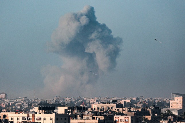 TOPSHOT - A picture taken from Rafah shows kites flown in the sky above the city as smoke billows during Israeli bombardment on Khan Yunis in the southern Gaza Strip on April 3, 2024, amid ongoing battles between Israel and the Palestinian militant group Hamas. (Photo by SAID KHATIB / AFP) (Photo by SAID KHATIB/AFP via Getty Images)