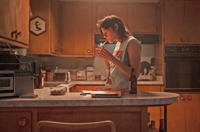 This image released by A24 shows Kristen Stewart in a scene from "Love Lies Bleeding." (Anna Kooris/A24 via AP)