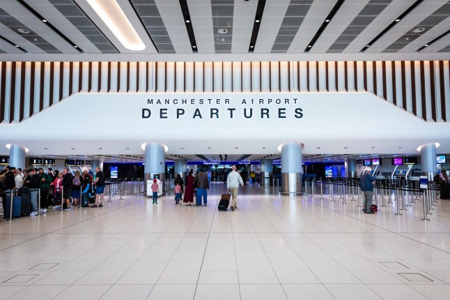 Terminal 2, Manchester Airport, UK - September 14, 2023. Air passengers and travellers walking through the new departure lounge at Terminal 2 of Manchester Airport