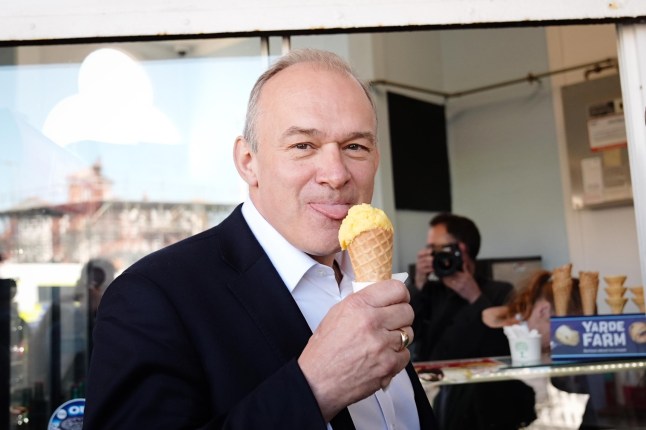 Liberal Democrat leader Sir Ed Davey eats ice cream on the promenade in Eastbourne, East Sussex, while on the General Election campaign trail. Picture date: Friday May 24, 2024. PA Photo. See PA story POLITICS Election LibDems. Photo credit should read: Aaron Chown/PA Wire