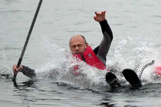 WINDERMERE, ENGLAND - MAY 28: Liberal Democrats Leader Ed Davey falls into the water while paddle boarding on Lake Windermere during a campaign visit, with Tim Farron, MP for Westmorland and Lonsdale, on May 28, 2024 in Windermere, England. The UK general election will be held July 4th. (Photo by Christopher Furlong/Getty Images)