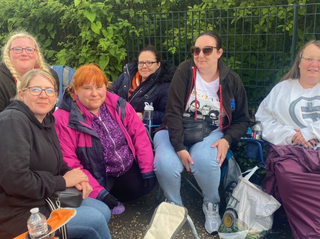 Early arrivals for the Take That concert - Maria Marshall, Emma Sargent, Nikki Hubbard, Samantha Emmerson, Nikki Foulger and Nicola Landles. Release date May 28 2024. Diehard Take That fans have been queuing up for their concert 36 hours before the gates open. Debra Legg, 36, had made the near four hour trip from Swindon to be first in the queue outside Norwich City's Carrow Road stadium ahead of the gig tonight (Tues). She said: "I have loved Take That since they first started." Debra, who had seen them twelve times already on their tour, arrived at 5am on Monday morning to secure a spot in the queue. Gates don't open until 5pm tonight. She added: "There is always an amazing atmosphere in the queue - it is very addictive." The iconic boyband - who now consist just three members, Gary Barlow, Mark Owen and Howard Donald - previously sold out the football ground in 2017 and 2019.