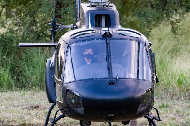 Mandatory Credit: Photo by Kevin McDonald/Bav Media/REX/Shutterstock (12816944b) Tom Cruise (left) landing his helicopter in Hoedspruit in South Africa after a days filming of Mission: Impossible 8 in the area. Crowds gathered to greet Tom Cruise as he landed in the small town of Hoedspruit in South Africa after a day of filming for Mission: Impossible 8. 'Mission: Impossible 8' filming, Hoedspruit, South Africa - 17 Feb 2022 The film star smiled and waved as fans of all ages waited to see him land his helicopter and transfer to a shuttle car to go back to his lodgings. The 59-year-old actor, who was wearing a navy blue T shirt and jeans, removed his face mask so fans could take photos. He was accompanied by the director of Mission Impossible, Christopher McQuarrie, who was spotted carrying his dog. Last week two bright yellow biplanes were seen arriving in the area on the back of a truck.