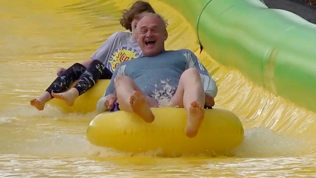 Liberal Democrat leader Sir Ed Davey rides down the Ultimate Slip n Slide attraction near Frome, Somerset, while on the General Election campaign trail. Picture date: Thursday May 30, 2024. PA Photo. See PA story POLITICS Election LibDems. Photo credit should read: Rod Minchin/PA Wire