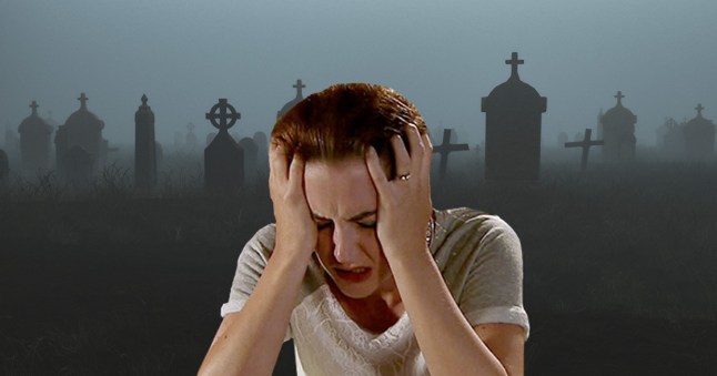 Ella with her head in her hands and a graveyard backdrop in Emmerdale