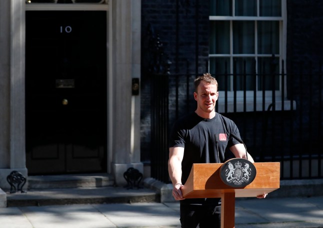 A worker sets up the lectern for British Prime Minister Theresa May to speak in the street outside 10 Downing Street in London, England, Friday, May 24, 2019. (AP Photo/Alastair Grant)