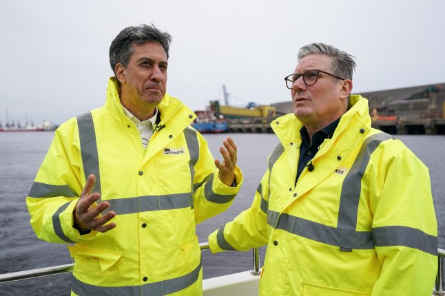 TEESSIDE, ENGLAND - APRIL 18: Labour Leader Keir Starmer (R), and Shadow Secretary of State of Climate Change and Net Zero, Ed Miliband take a boat trip on the River Tees during a visit to PD ports on April 18, 2024 in Teesside, England. Labour says they will "Build it in Britain" with the most significant investment in Britain's ports in a generation, as part of their Green Prosperity Plan to support 650,000 good jobs nationwide, with many thousands in the Tees Valley. (Photo by Ian Forsyth/Getty Images)