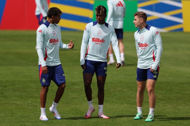 Spain's forward #19 Lamine Yamal (L), Spain's midfielder #17 Nico Williams (C) and Spain's forward #25 Fermin Lopez speak during the training session of Spain's national football team ahead of the UEFA Euro 2024 football Championship at the team's base camp in Donaueschingen on June 13, 2024. (Photo by LLUIS GENE / AFP) (Photo by LLUIS GENE/AFP via Getty Images)