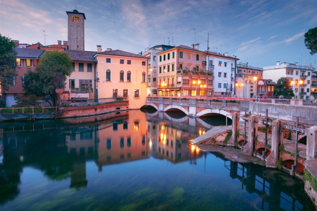 Cityscape image of historical center of Treviso, Italy at sunset.