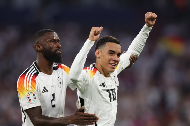 MUNICH, GERMANY - JUNE 14: Jamal Musiala of Germany celebrates with teammate Antonio Ruediger after scoring his team's second goal during the UEFA EURO 2024 group stage match between Germany and Scotland at Munich Football Arena on June 14, 2024 in Munich, Germany. (Photo by Alexander Hassenstein/Getty Images)