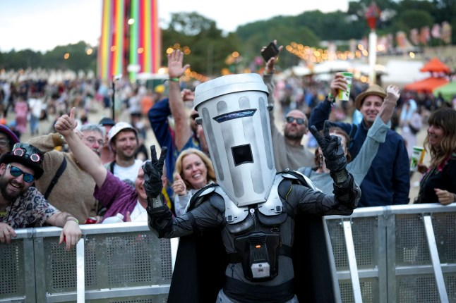 Count Binface posing with festivalgoers at Glastonbury Festival, Worthy Farm, Somerset.