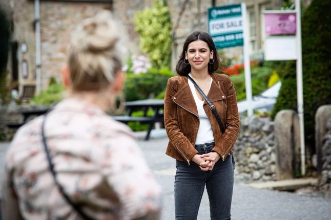 Meena speaks to Tracy on the street in Emmerdale