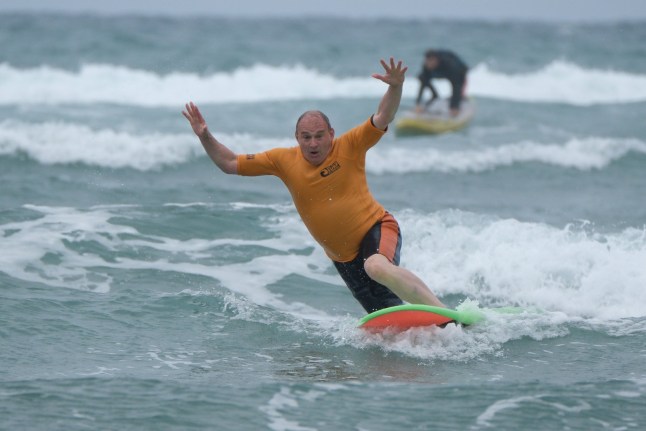 Liberal Democrat leader Sir Ed Davey falls from a surfboard during a visit to Big Blue Surf School in Bude in Cornwall, while on the General Election campaign trail. Picture date: Tuesday July 2, 2024. PA Photo. See PA story POLITICS Election LibDems. Photo credit should read: Matt Keeble/PA Wire