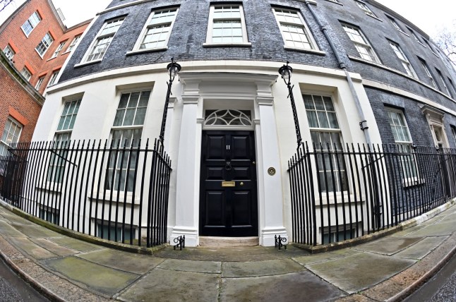 The door of Number 11 Downing Street, the official residence of Britain's Chancellor of the Exchequer, is pictured with a fisheye lens, in central London on March 5, 2024. Britain's Conservative government on Wednesday unveils a pre-election budget that could feature voter-friendly measures, with Prime Minister Rishi Sunak's party badly trailing main opposition party Labour in polls. (Photo by JUSTIN TALLIS / AFP) (Photo by JUSTIN TALLIS/AFP via Getty Images)