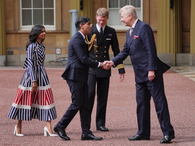 Sir Clive Alderton, Principal Private Secretary to The King and Queen(right) with Commander William Thornton, Royal Navy, Equerry to The King (2nd right) greet Rishi Sunak and his wife Akshata Murty, as he arrives at Buckingham Palace for an audience with King Charles III to formally resign as PM following the landslide General Election victory for the Labour Party. Picture date: Friday July 5, 2024. PA Photo. See PA story POLITICS Election. Photo credit should read: Jonathan Brady/PA Wire