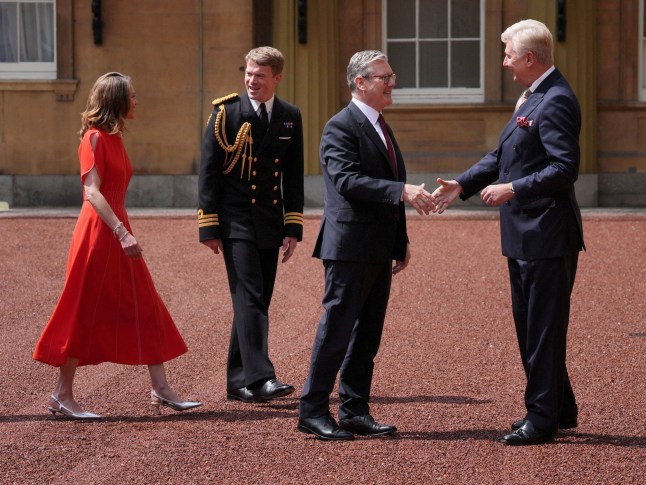 Sir Clive Alderton, Principal Private Secretary to the King and Queen (right) with Commander William Thornton, Royal Navy, Equerry to the King (2nd left) greet Sir Keir Starmer, and his wife Victoria Starmer, as he arrives at Buckingham Palace in London for an audience with King Charles III, where he will be invited to become Prime Minister and form a new government, following the landslide General Election victory for the Labour Party. Picture date: Friday July 5, 2024. Jonathan Brady/POOL via REUTERS