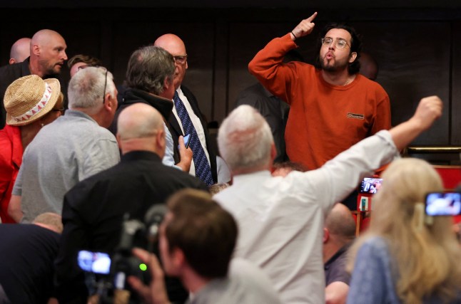 A heckler gestures as Britain's Reform UK Party Leader Nigel Farage speaks to the media, in London, Britain July 5, 2024. REUTERS/Belinda Jiao