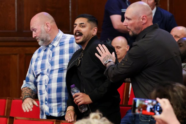 A heckler is escorted out as Britain's Reform UK Party Leader Nigel Farage speaks to the media, in London, Britain July 5, 2024. REUTERS/Belinda Jiao