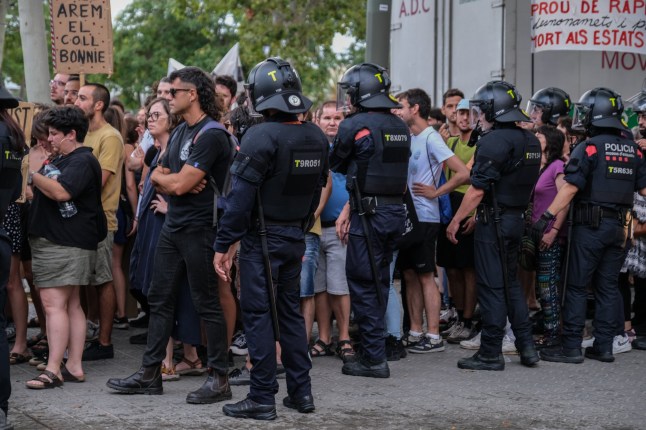 Mandatory Credit: Photo by Paco Freire/SOPA Images/Shutterstock (14575382aa) A line of regional police officers seen keeping protesters away from the terraces of Barceloneta restaurants mostly frequented by tourists. More than 3,000 people have demonstrated against the tourist overcrowding suffered by the city of Barcelona and in favor of tourism reduction policies. The demonstration has been symbolically closing hotel establishments, bars and restaurants while heading towards Barceloneta, one of the neighborhoods that suffers the most from the presence of tourism. Demonstration for tourism decrease in Barcelona, Spain - 06 Jul 2024