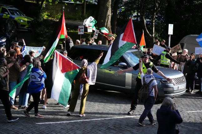 Pro-Palestinian protesters as the car convoy carrying Prime Minister Sir Keir Starmer leaves Bute House in Edinburgh following his meeting with First Minister of Scotland John Swinney during the PM's tour of the UK following Labour's victory in the 2024 General Election. Picture date: Sunday July 7, 2024. PA Photo. See PA story POLITICS Labour. Photo credit should read: Andrew Milligan/PA Wire