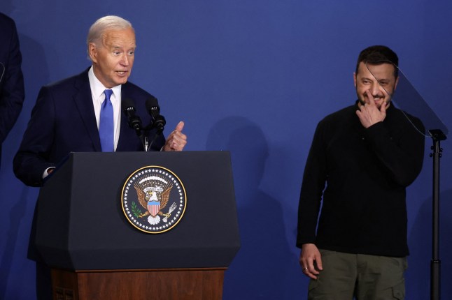 U.S. President Joe Biden speaks at a Ukraine Compact meeting, as Ukraine's President Volodymyr Zelenskiy stands next to him, on the sidelines of the NATO's 75th anniversary summit in Washington, U.S. July 11, 2024. REUTERS/Yves Herman