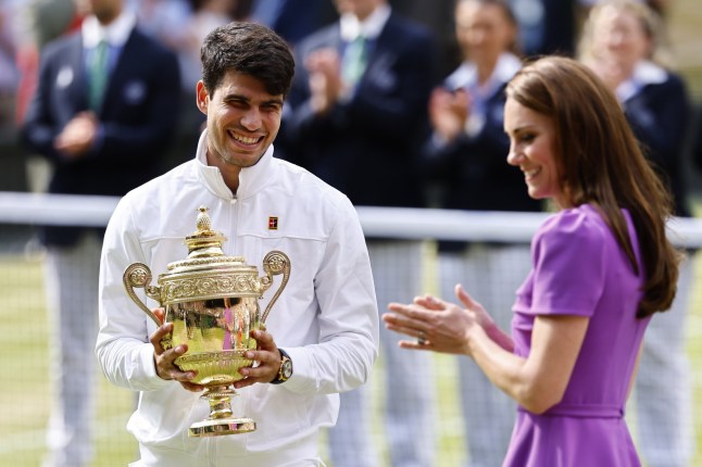 epa11477821 Carlos Alcaraz of Spain receives the trophy from Britain's Catherine, Princess of Wales after winning the Men's final against Novak Djokovic of Serbia at the Wimbledon Championships, Wimbledon, Britain, 14 July 2024. EPA/TOLGA AKMEN EDITORIAL USE ONLY