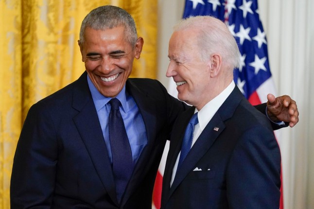 Former President Barack Obama hugs President Joe Biden after Biden spoke about the Affordable Care Act, in the East Room of the White House in Washington, Tuesday, April 5, 2022. (AP Photo/Carolyn Kaster)