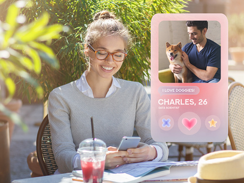 Young woman using dating app on phone, sitting in cafe outdoors