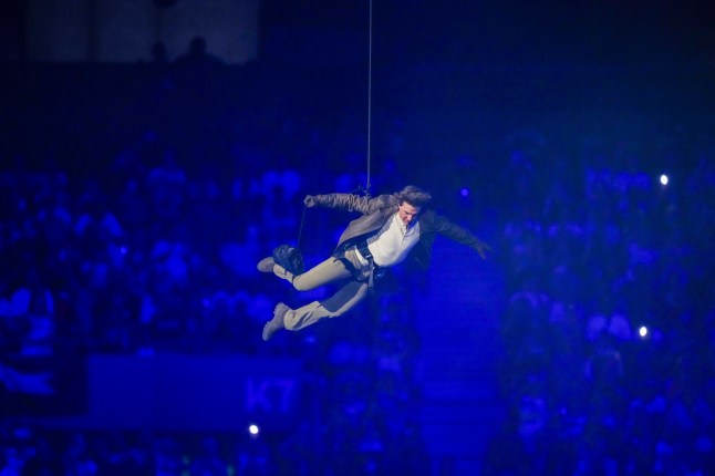 Tom Cruise is lowered on the State de France during the 2024 Summer Olympics closing ceremony, Sunday, Aug. 11, 2024, in Saint-Denis, France. (AP Photo/Natacha Pisarenko)