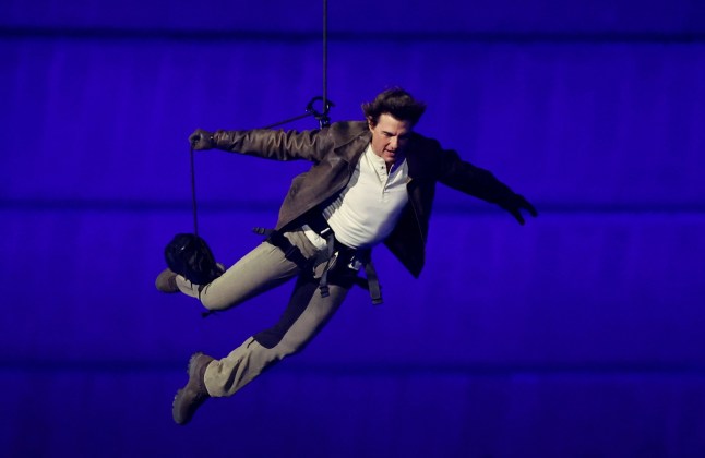 Tom Cruise abseils into the Paris Olympics closing ceremony