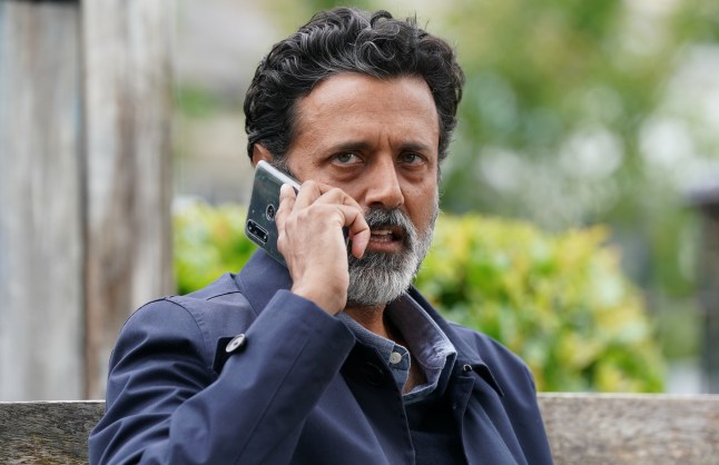 Nish on the phone in EastEnders