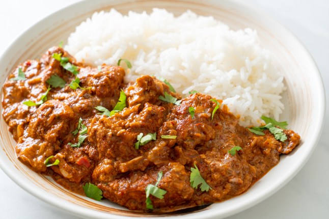 Chicken tikka masala with rice on plate