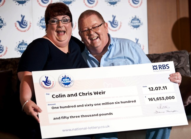 Colin Weir (R) and his wife Chris pose for pictures during a photocall in Falkirk, Scotland, on July 15, 2011, after winning a record GBP161m (184m euros/259m USD) in the EuroMillions Lottery, on July 15, 2011. The Euro Millions lottery, launched in 2004, is now played by nine countries across western Europe: Austria, Belgium, Britain, France, Ireland, Luxembourg, Portugal, Spain and Switzerland. AFP PHOTO/ WATTIE CHEUNG (Photo credit should read Wattie Cheung/AFP via Getty Images)