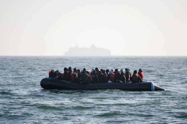 (FILES) Migrants wait for help from the Abeille Languedoc ship after their boat's generator broke down in French waters while they were trying to cross the Channel illegally to Britain, off the coasts of Boulogne-sur-Mer, northern France, on May 9, 2022. Two migrants died on August 11, 2024, in the Channel off the northern coast of France trying to reach Britain by boat, French maritime authorities said. (Photo by Sameer Al-DOUMY / AFP) (Photo by SAMEER AL-DOUMY/AFP via Getty Images)