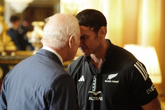 King Charles III (left) performs a hongi (a traditional Maori greeting) with team manager Allan Bunting as he meets New Zealand's Black Ferns rugby union team at Buckingham Palace in London. Picture date: Wednesday September 11, 2024. PA Photo. See PA story ROYAL King. Photo credit should read: Aaron Chown/PA Wire